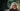 Woman with white hair and glasses smiling outdoors